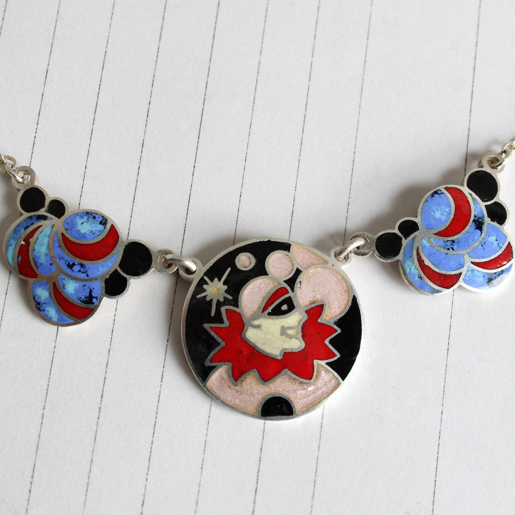 colorful enamel necklace with a pendant of a pierrot clown with a red collar and black mask 