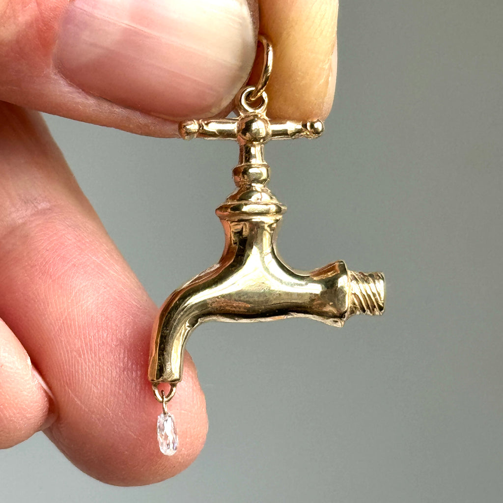 yellow gold antique style faucet charm with small diamond briolette as the drip of water