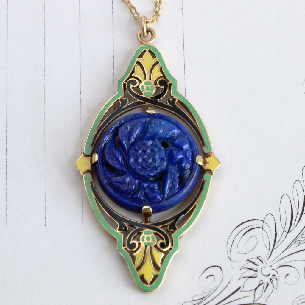 art deco yellow gold pendant with yellow and green enamel and a lapis lazuli carved flower disc in the center