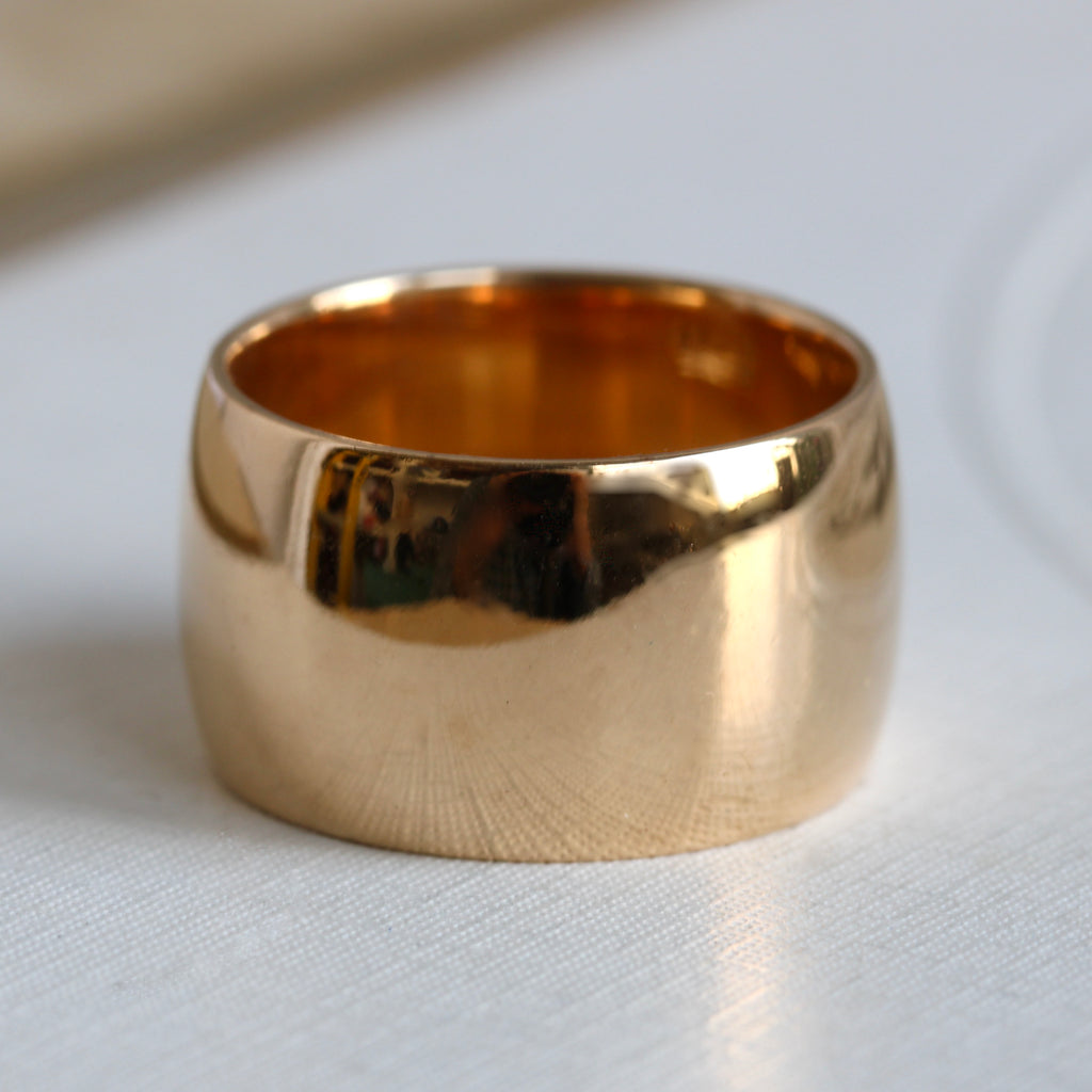 very wide 18k yellow gold wedding or stacking band with a smooth exterior