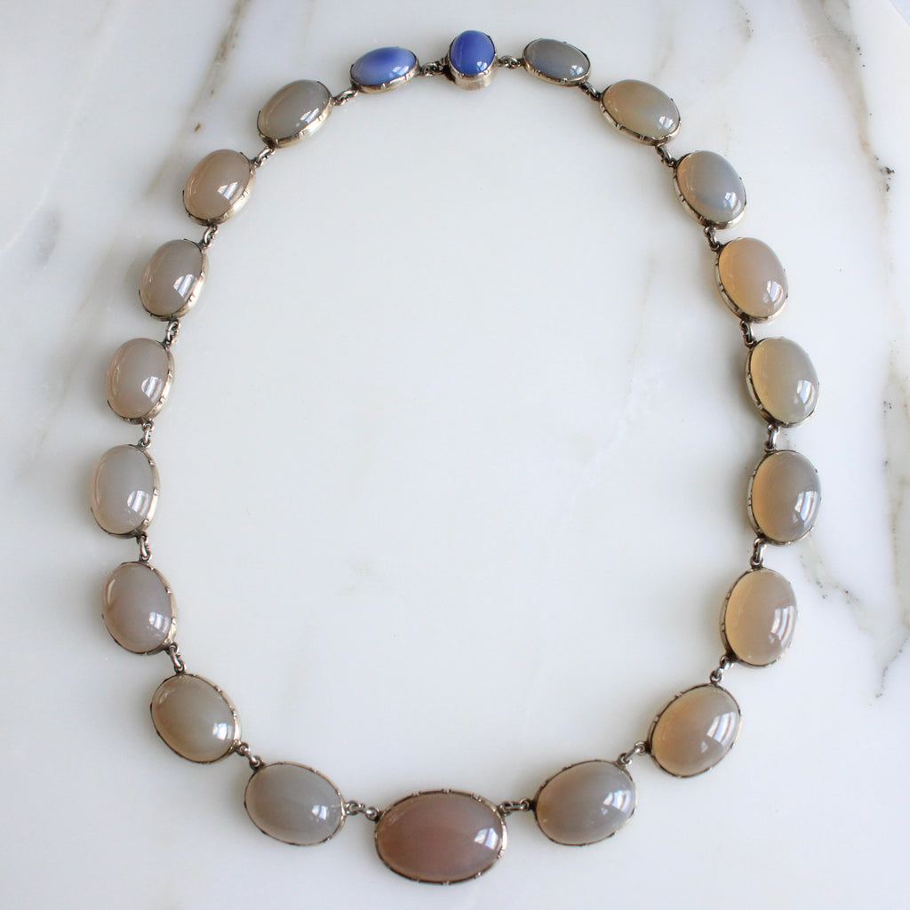 collar necklace of graduated taupe/grey/blue stone cabochons arranged in a line, set in silver bezels