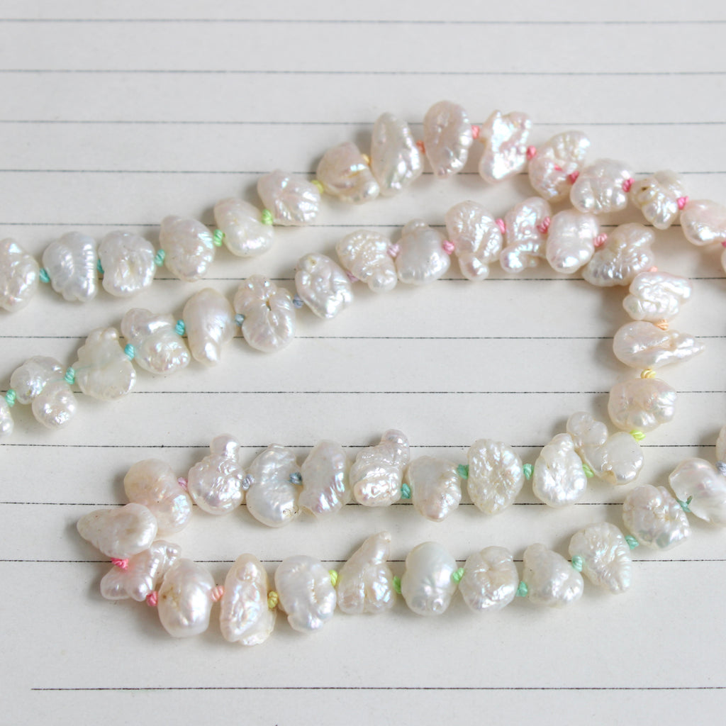 irregular shaped freshwater pearl necklace knotted on rainbow silk