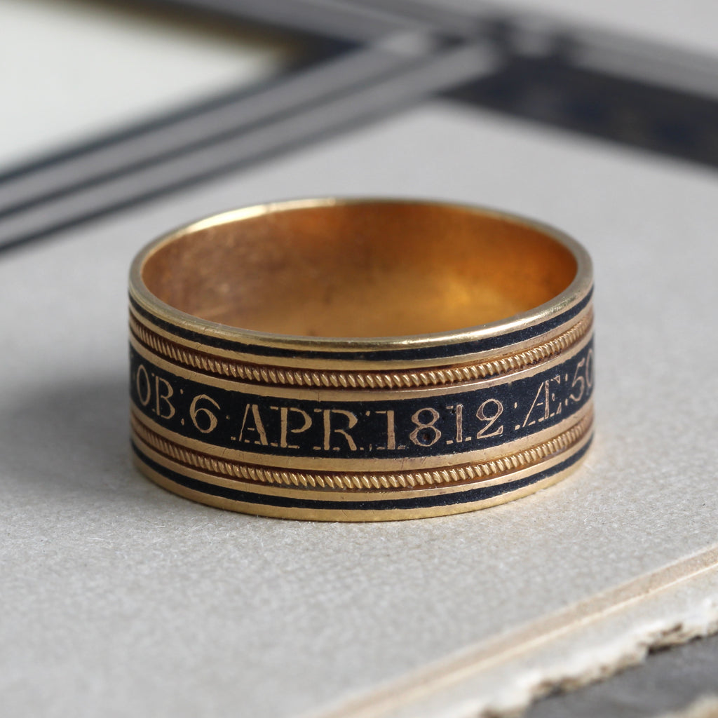 gold mourning band style ring with date and name of deceased in black enamel dated 1812