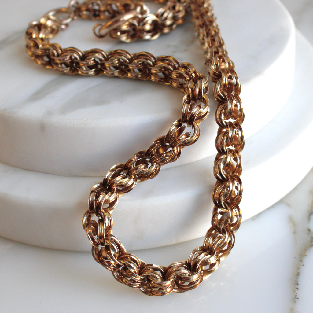 thick gold chain necklace with doubled round links and a ribbed look