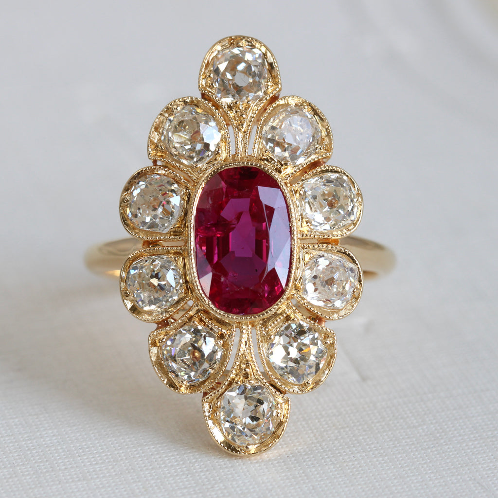 marquise shaped ring with natural deeply saturated ruby surrounded by large bright old-cut diamonds 