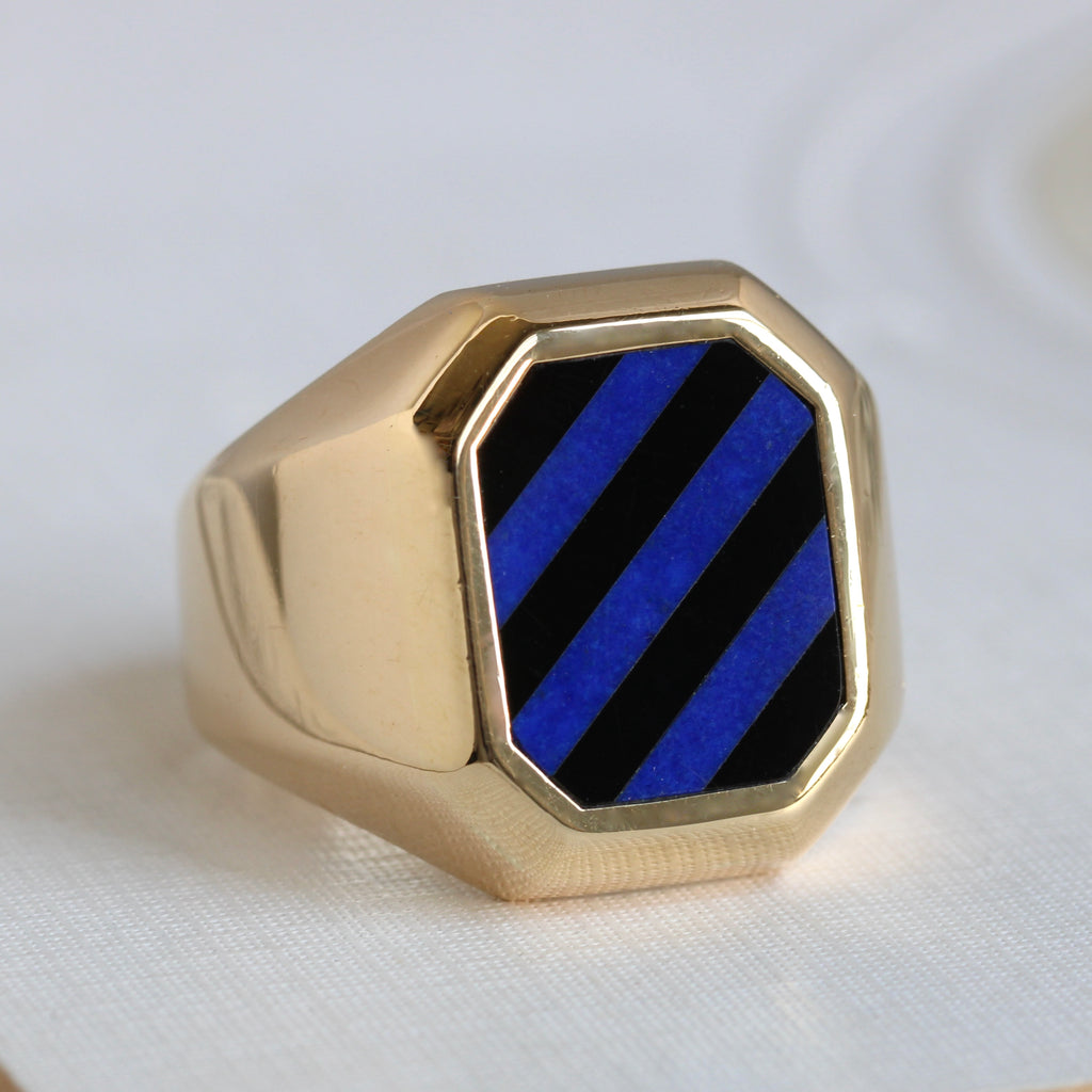 chunky yellow gold signet with a striped blue lapis and black onyx panel on the front