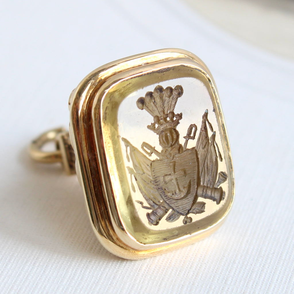 citrine carved with family crest of five plumes in a coronet above a shield with cross, swords and cannons crossed behind, in a gold fob