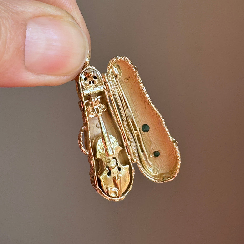 realisitic miniature violin charm in yellow gold in a case that opens.