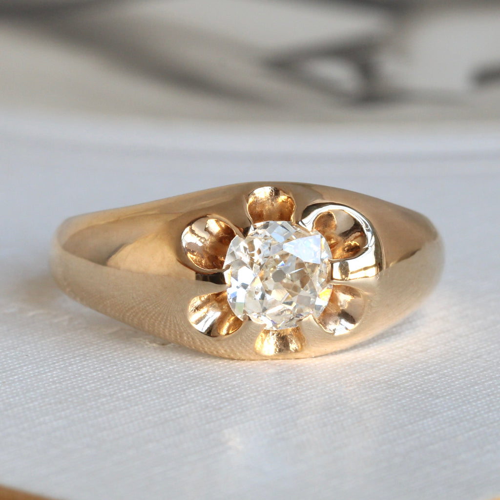 yellow gold ring with a circle of low profile prongs holding a square shaped old cut diamond