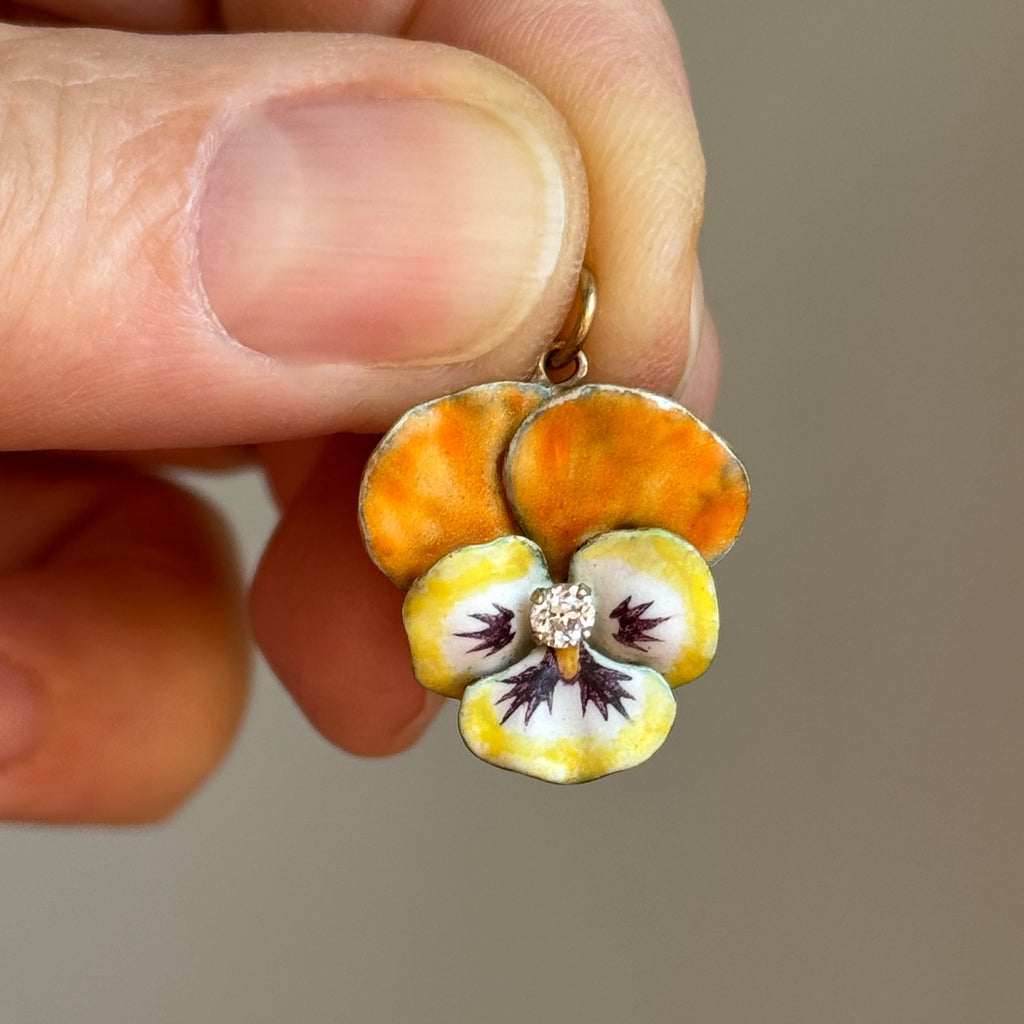 pansy flower charm in yellow gold enameled reaslitically in lemon yellow, orange and white with a diamond in the center