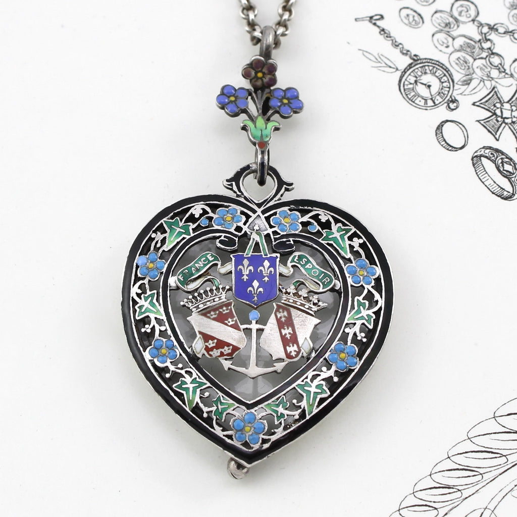 Antique sterling silver and blue and green enamel heart shaped locket with crests and flowers decoration
