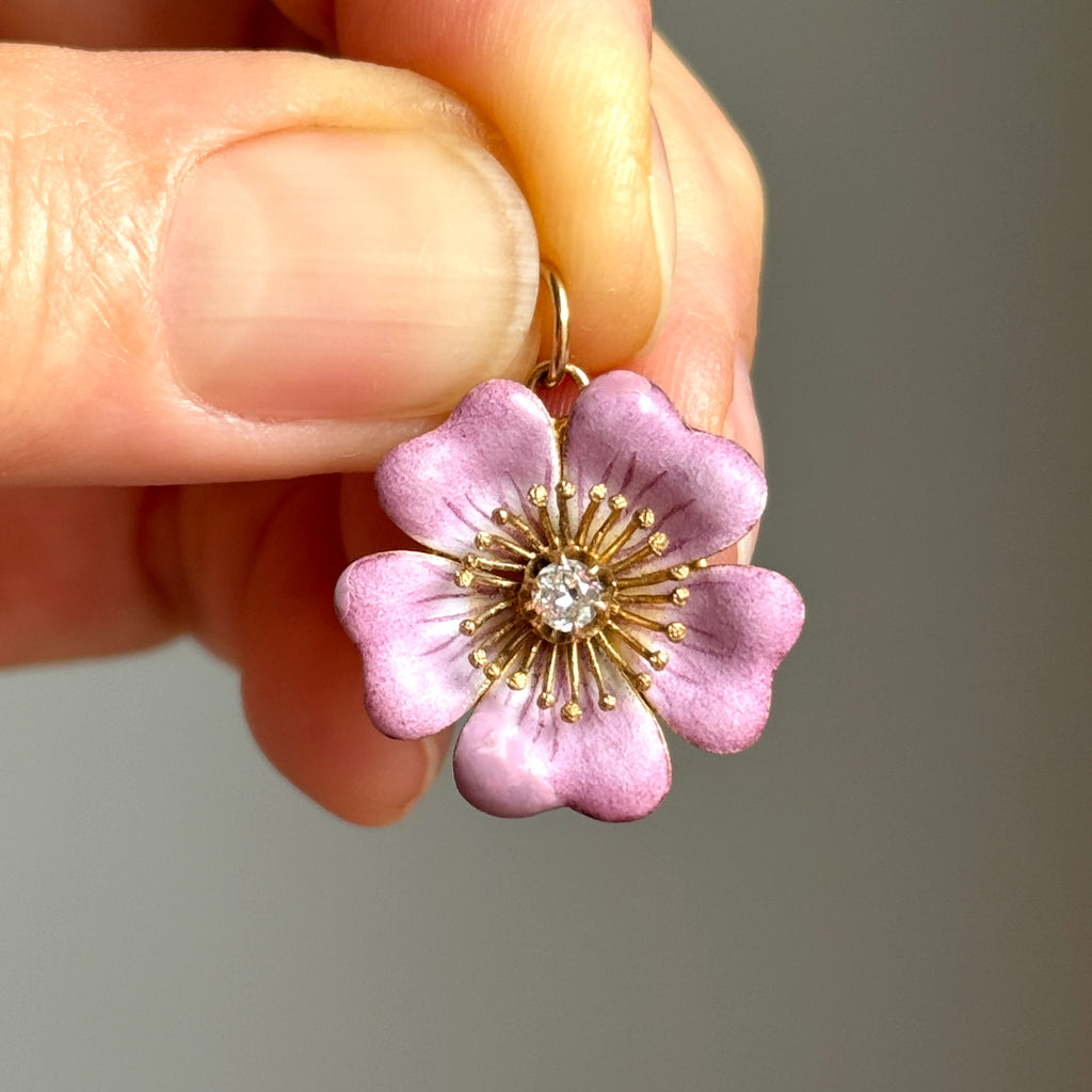 pinkish purple enamel flower pendant in yellow gold with a diamond at the center