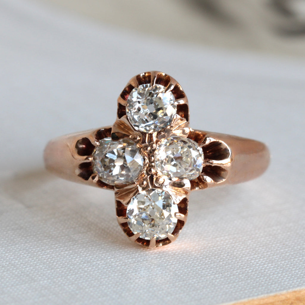 antique yellow gold ring with a cross cluster of four old cut diamonds in prongs