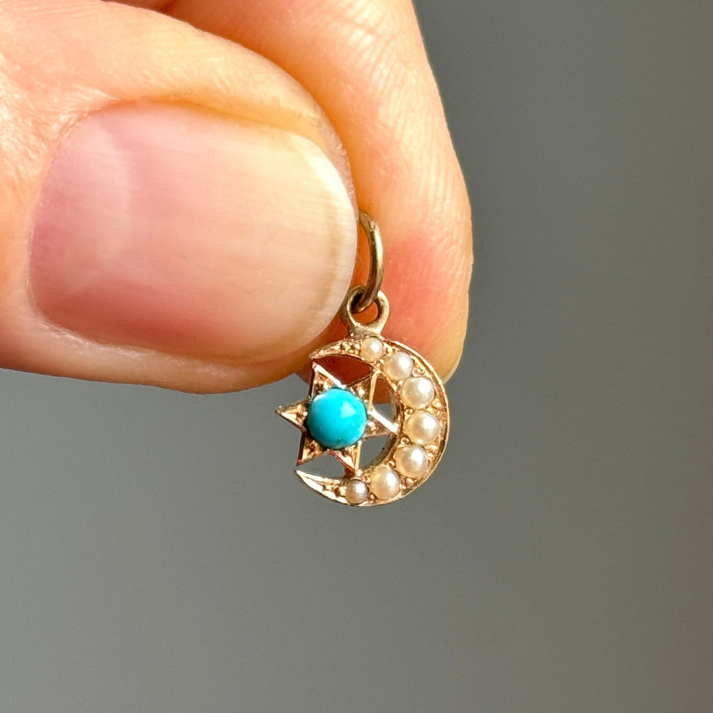 antique yellow gold crescent moon charm, the moon accented with pearls with a star in the center of the curve set with a blue turquoise