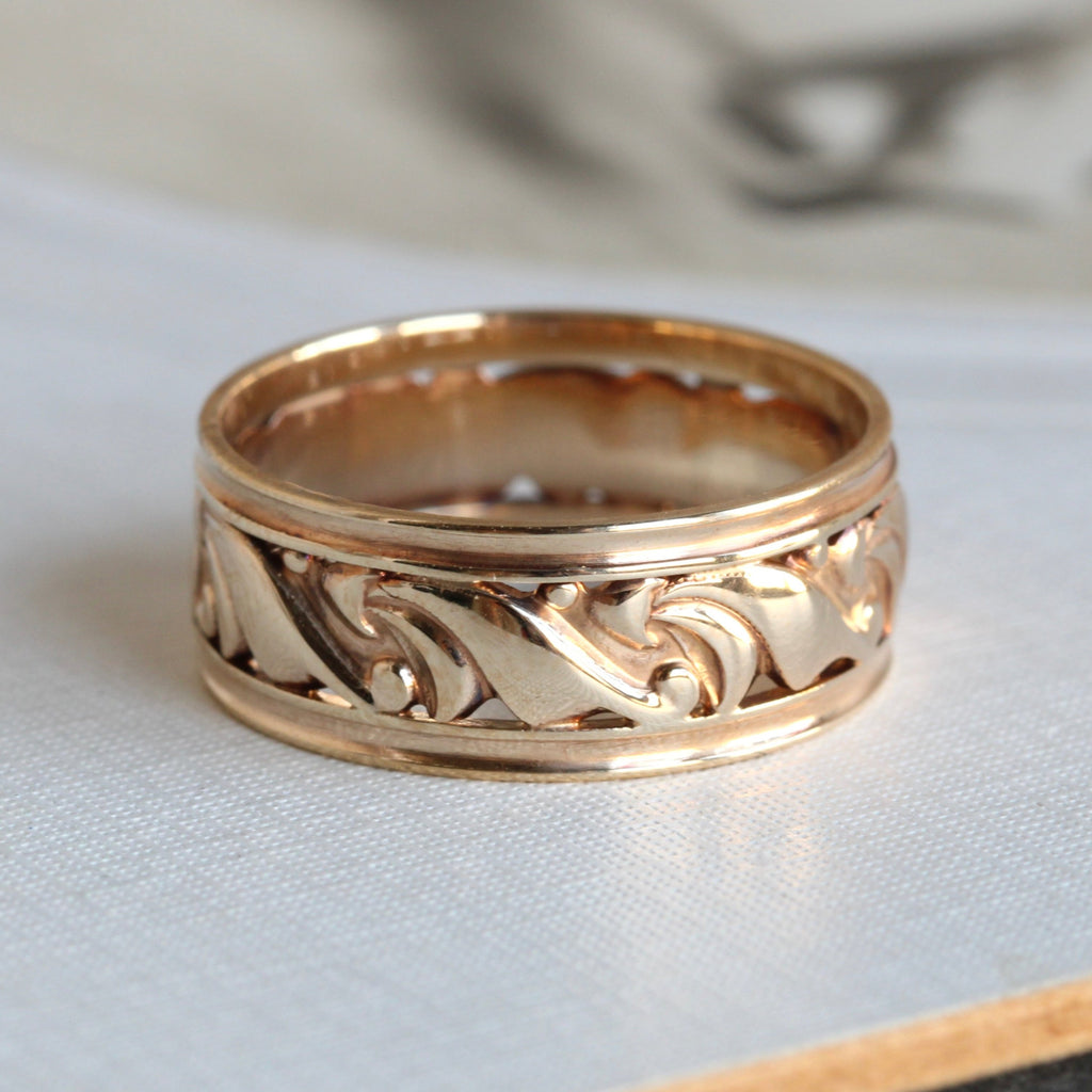 wide yellow gold band with a scroll pattern all around