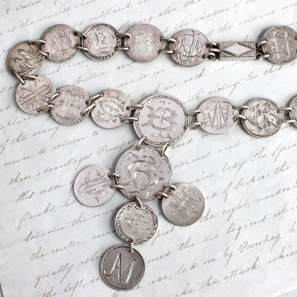 antique necklace made from sterling silver dimes and quarters with engraved monograms, the coin dates ranging from 1841 to 1877