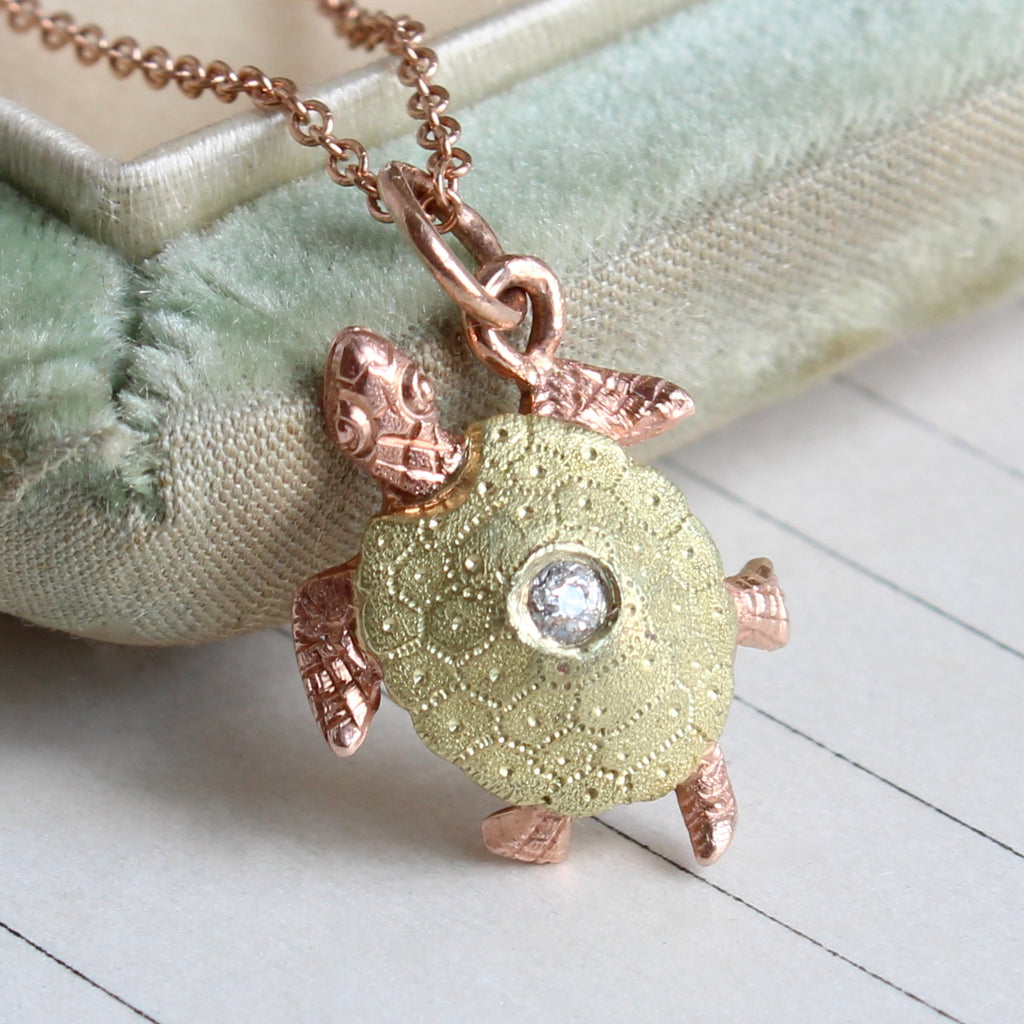 turtle charm in rose and green gold with engraved shell pattern and a diamond on top