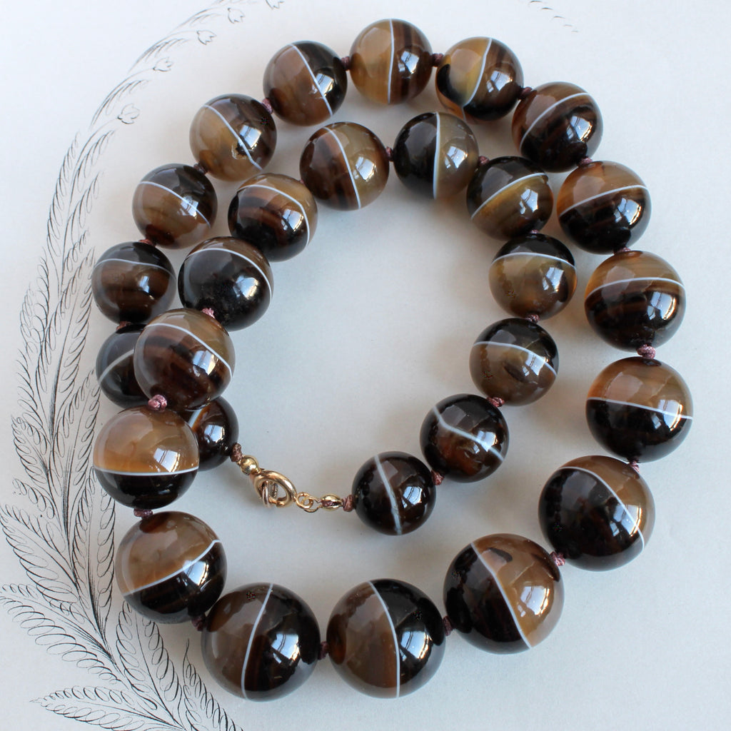 antique necklace of large sized round agate beads striped in chocolate caramel and cream colors 