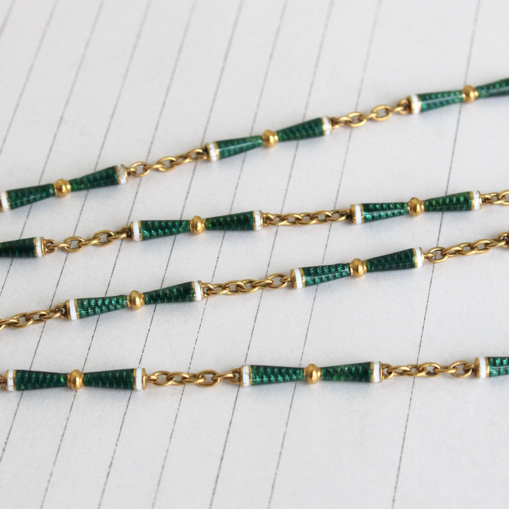 gold chain with bar links enameled in green and white with cable links between the bars.