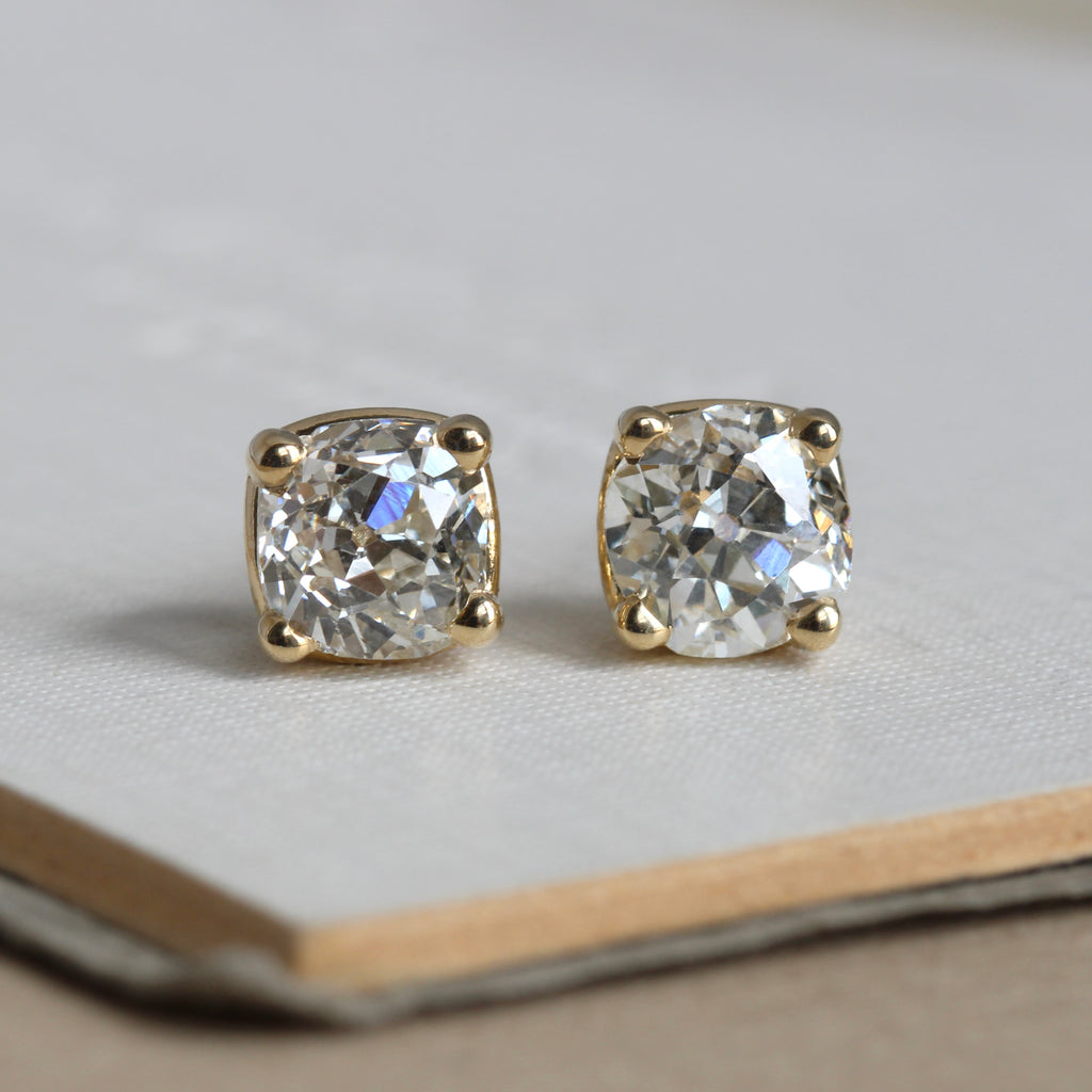 old mine cut diamonds in a cushion shape set in yellow gold 