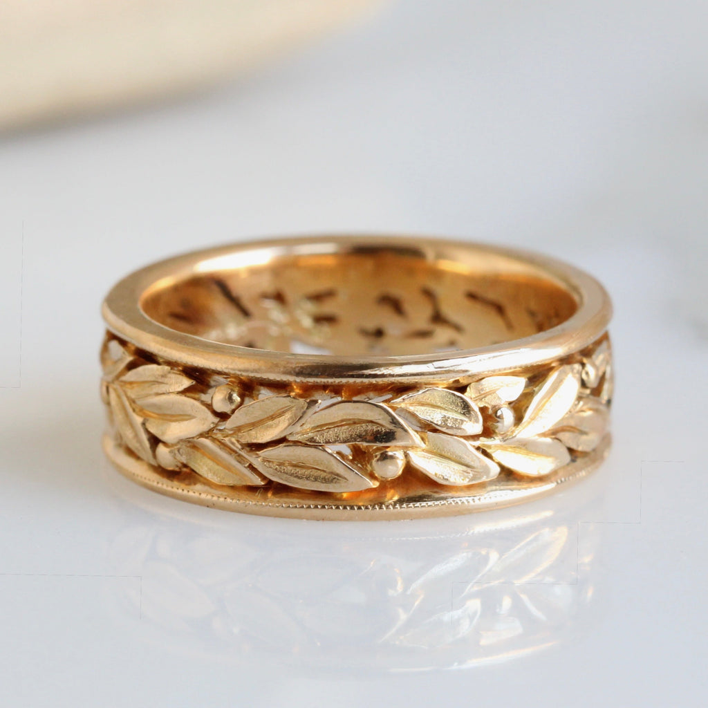 thick gold band carved all around with laurel leaves