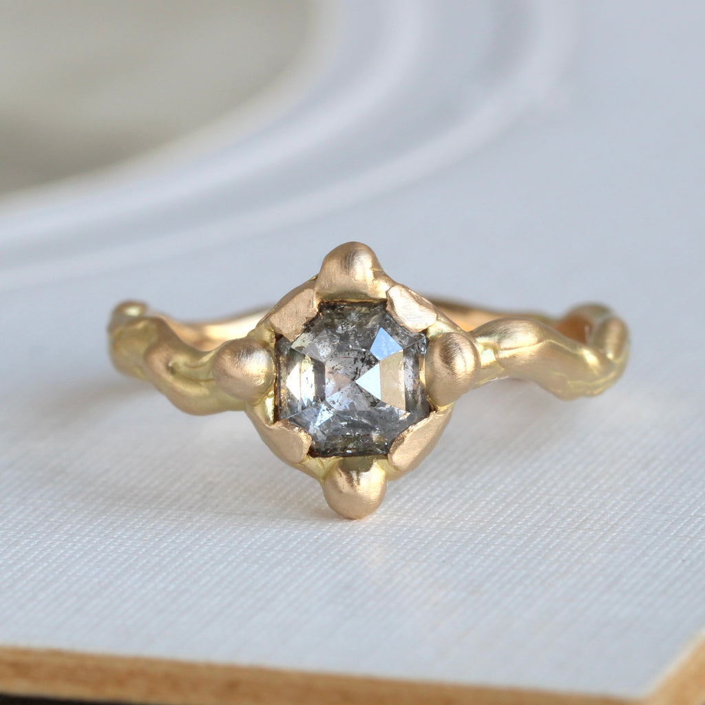 square rose cut diamond in a pyramid shape with salt and pepper color pattern in gold branch style setting