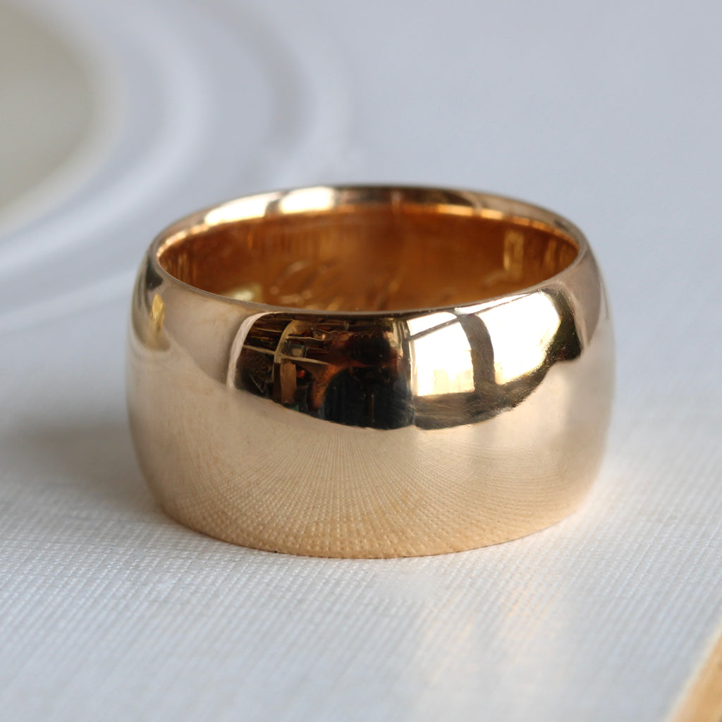 wide gold band with a rounded profile