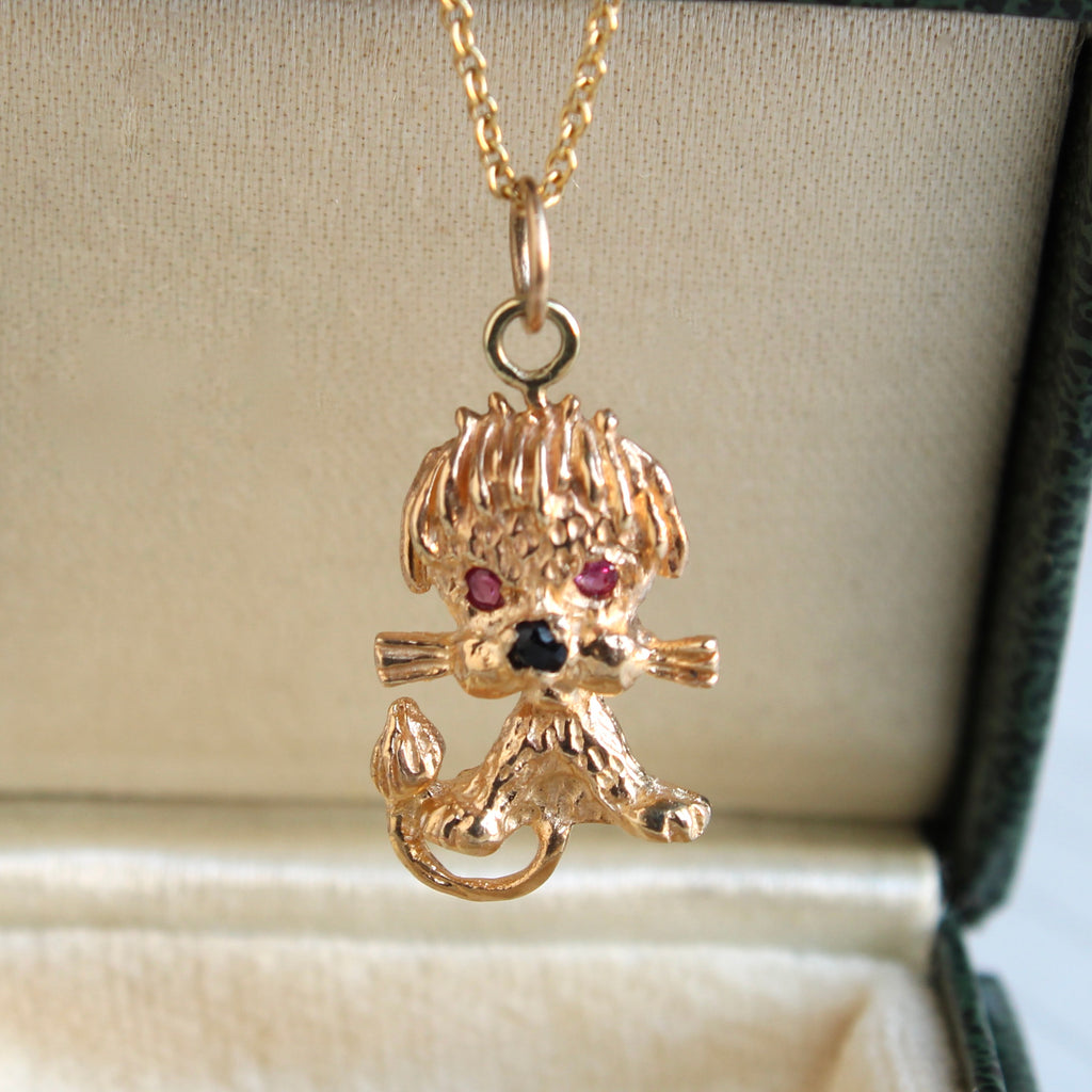 gold lion cub charm with ruby eyes on a 14k chain