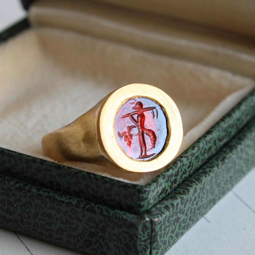 high karat gold ring with reddish stone carved with fortuna the goddess of good luck and plentiful harvest