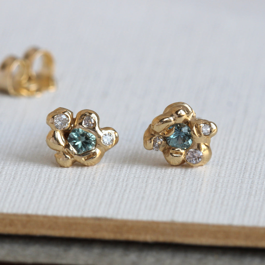 organic style gold studs set with teal blue spinel and white diamonds