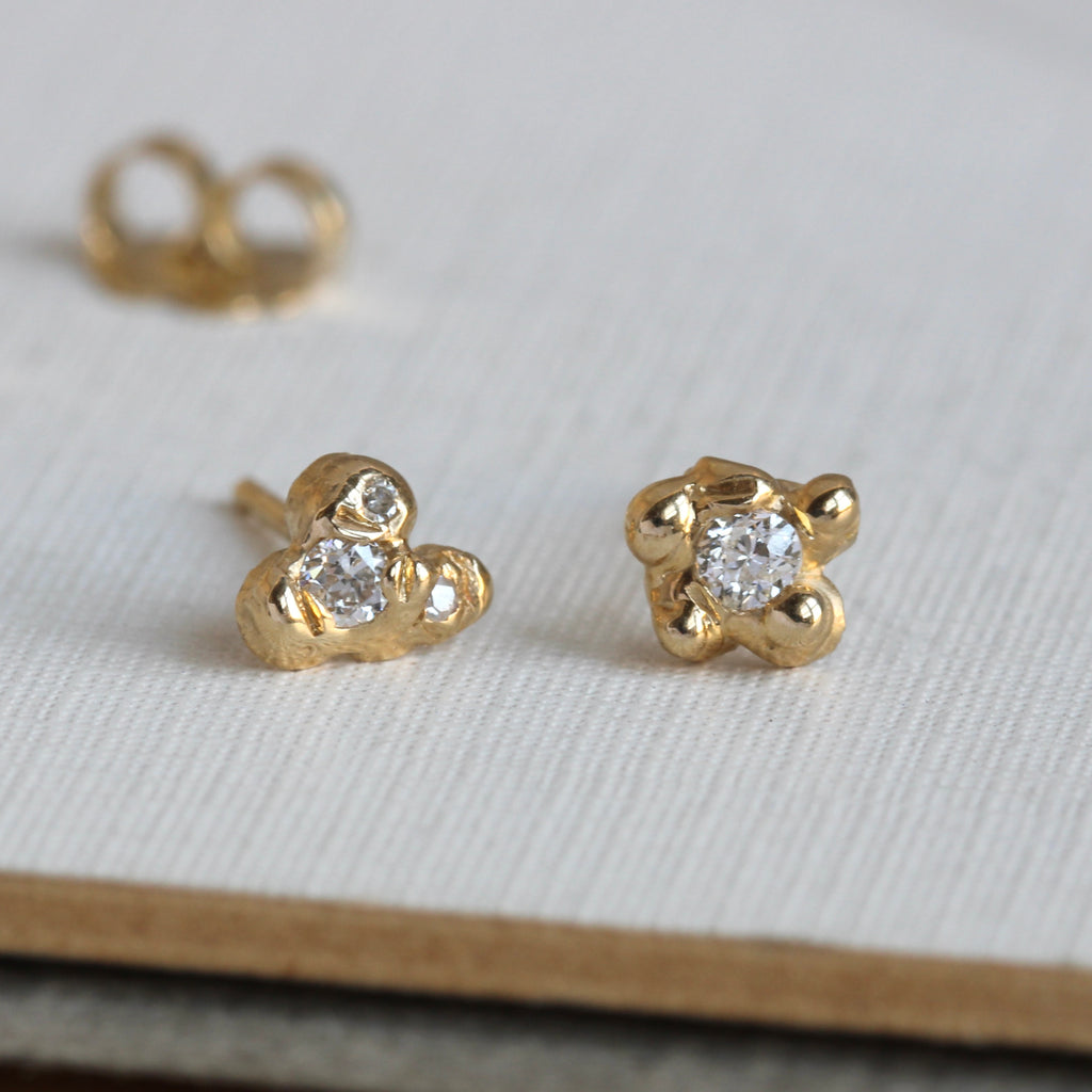 yellow gold studs in an organic style set with natural diamonds