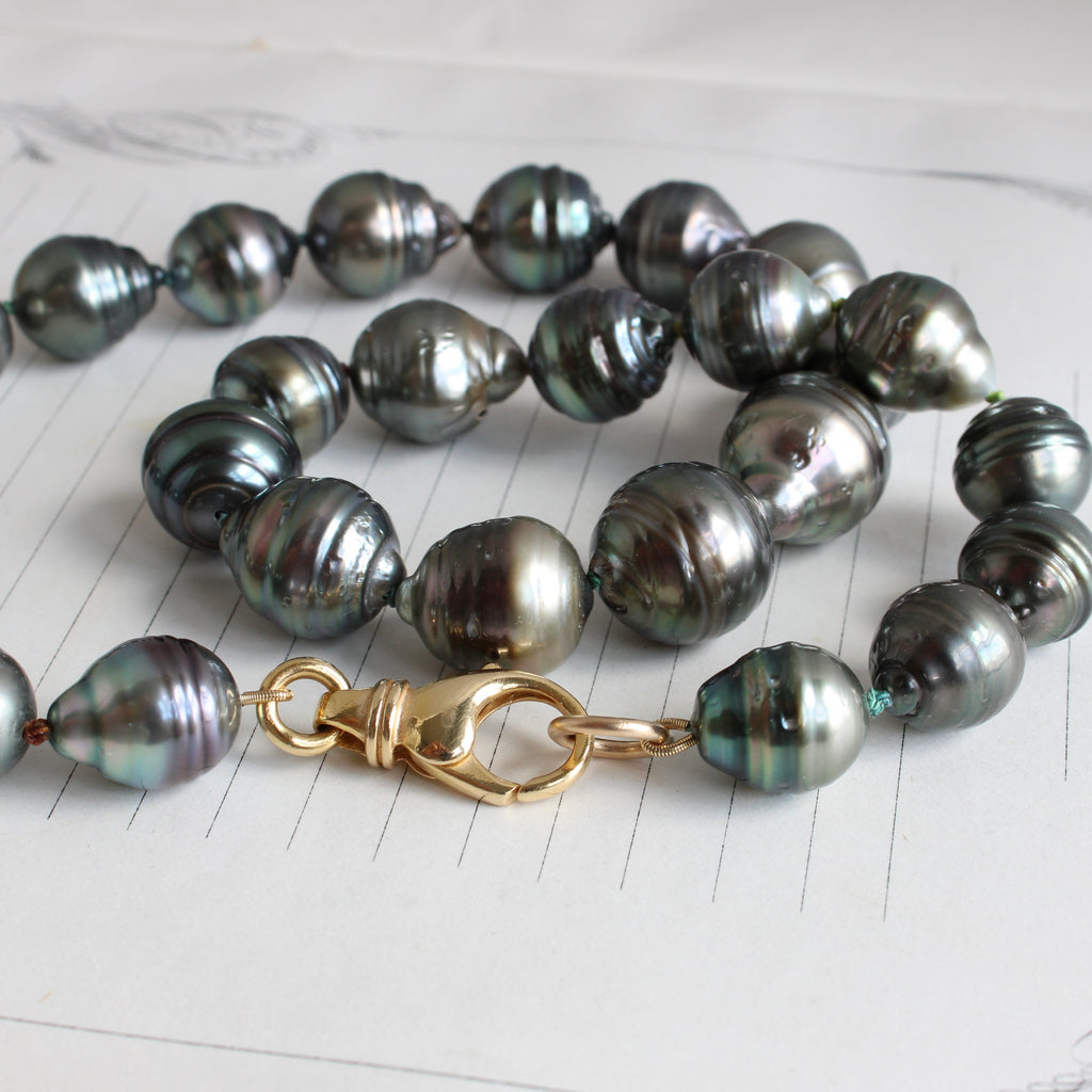 tahitian baroque black pearl necklace knotted on multi-color silk with a large yellow gold lobster clasp