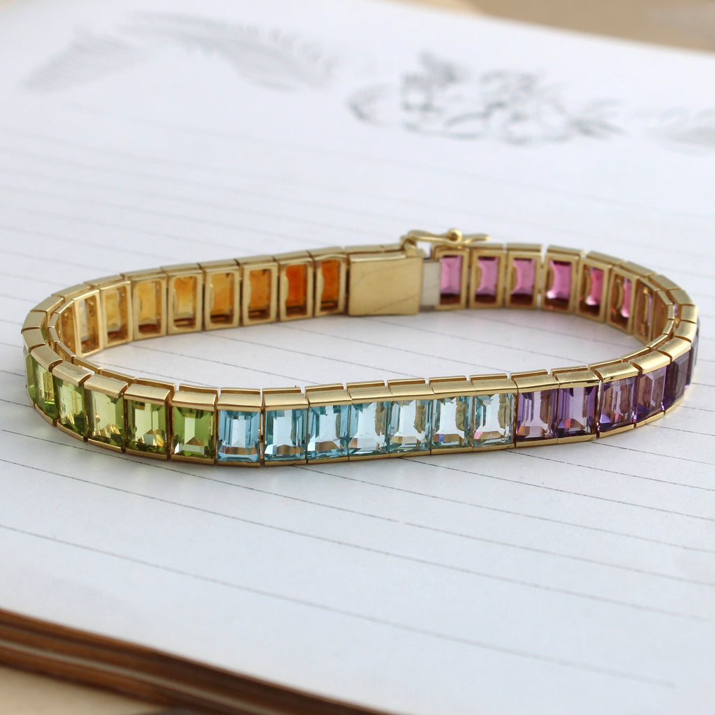 yellow gold line or tennis bracelet with multi color gemstones like amethyst, citrine, garnet, peridot and topaz