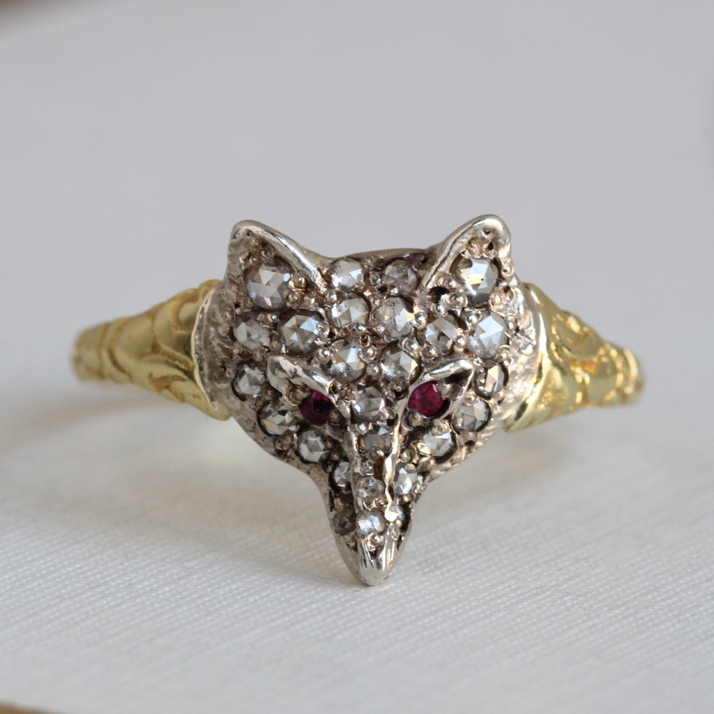 fox ring with silver fox face studded with rose cut diamonds on a gold band