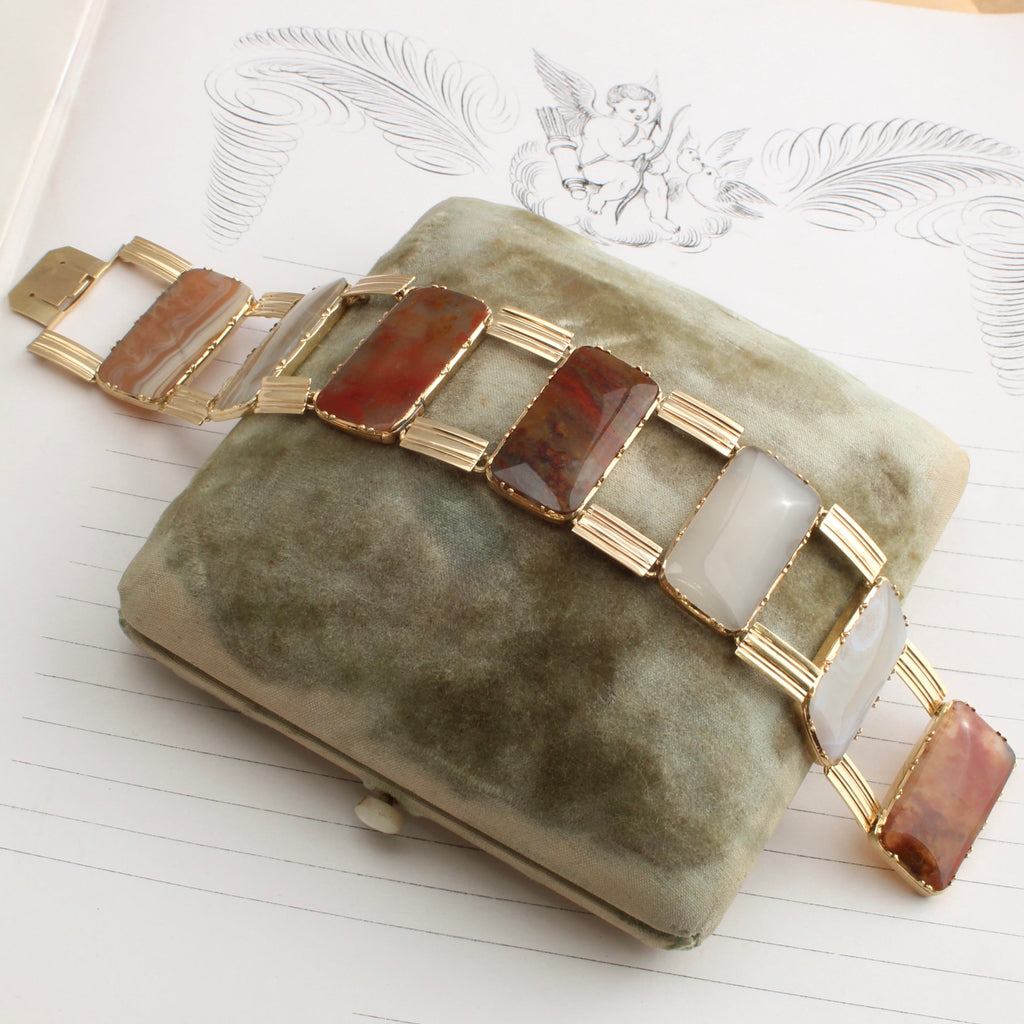 yellow gold bracelet of different agates cut in rectangular panels connected be wide bar links