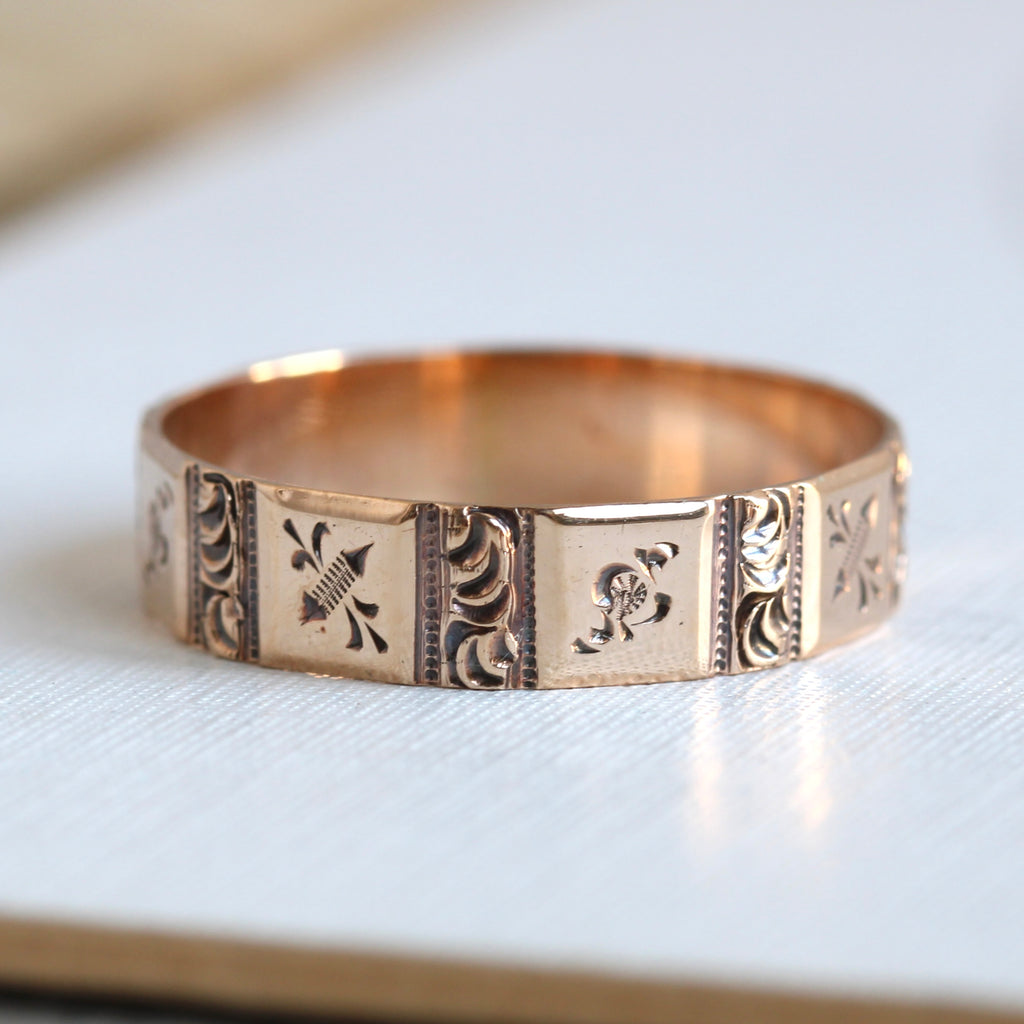 rose gold stacking ring with engraved floral decoration in square sections around the band