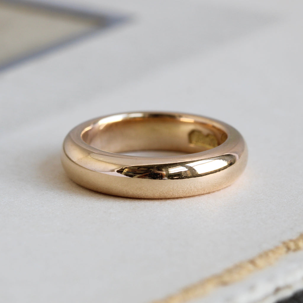 antique yellow gold band with a slightly rosy tint in a smooth rounded profile similar to a modern comfort fit