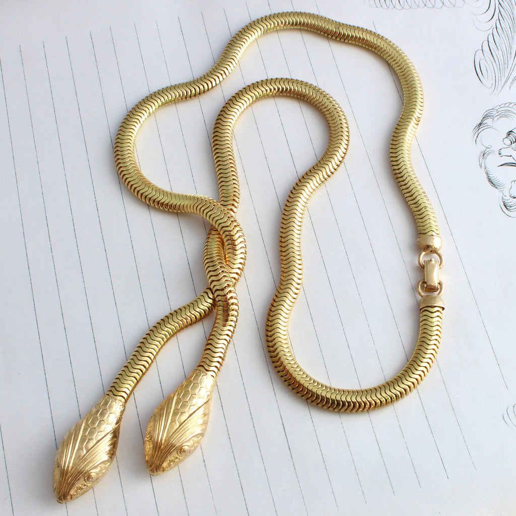 yellow metal snake necklace with tobagas chain and two snake head pendant drops