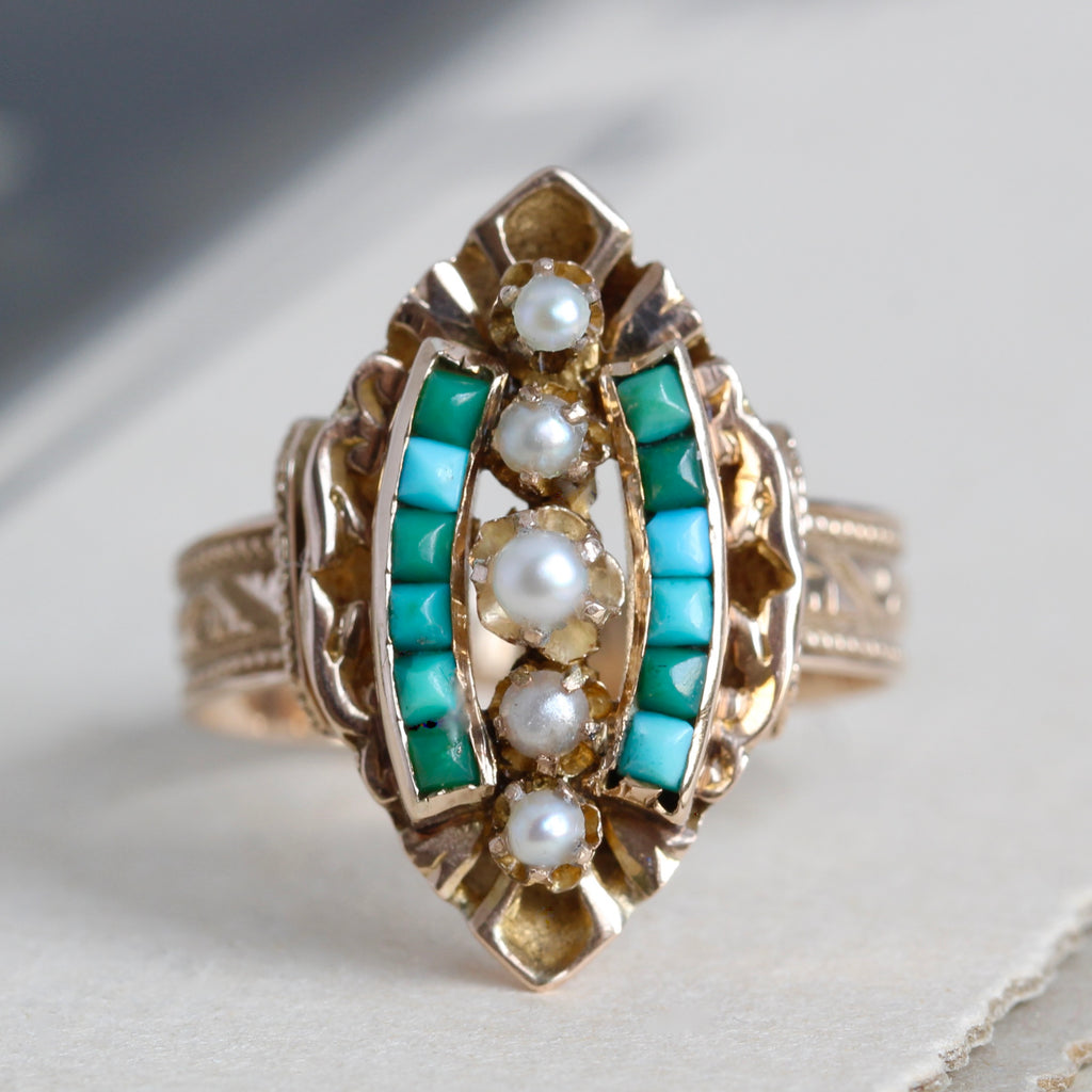 Antique yellow gold ring with dainty pearls and turquoise cabochons in a marquis-shaped setting.