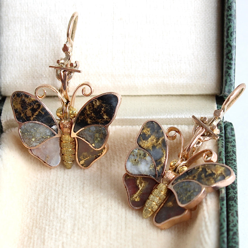 antique rose gold butterfly earrings with the wings set in different colored quartz that are all veined with pure gold