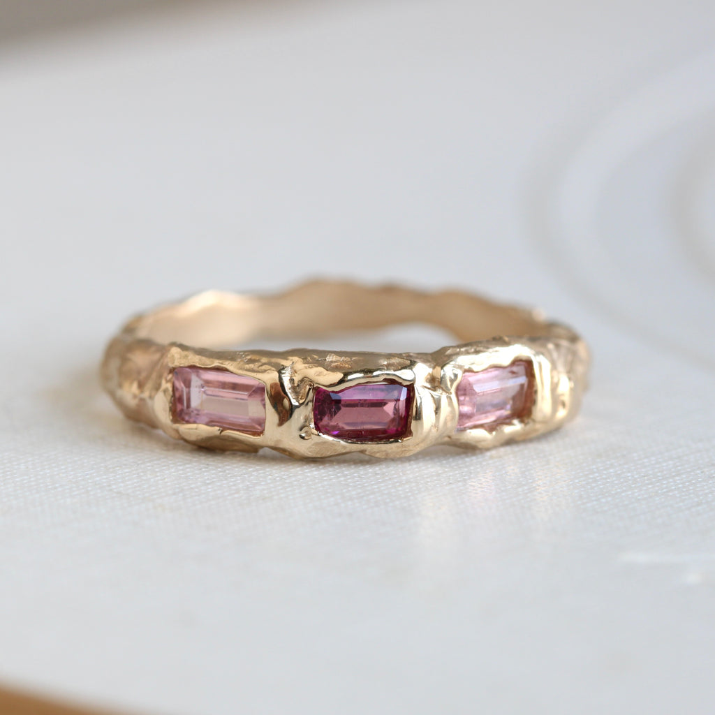 natural branch style ring in yellow gold with three rectangular tourmaline across the front in three different shades of pink