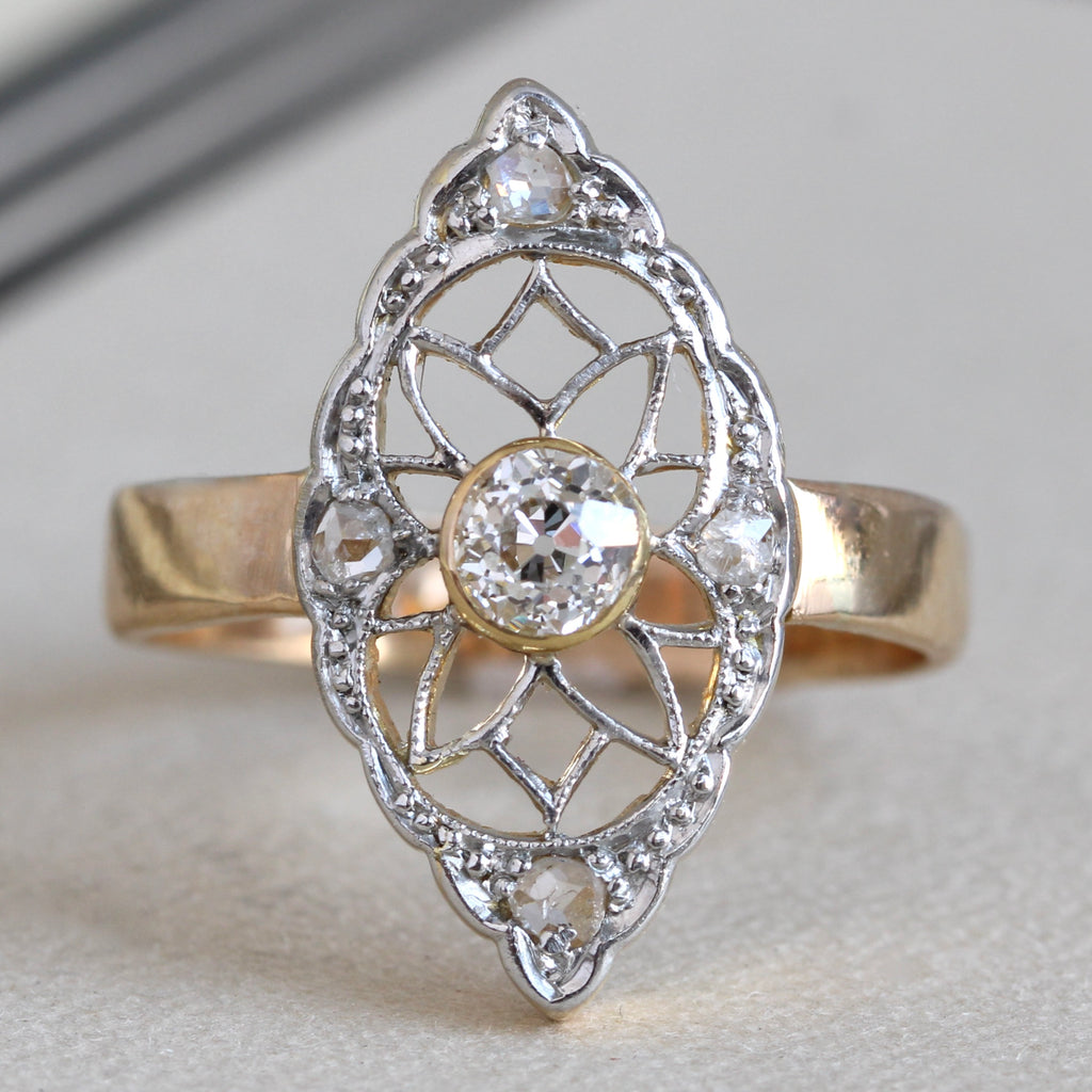 antique ring with platinum navette shaped filigree face set with round diamonds and a yellow gold band