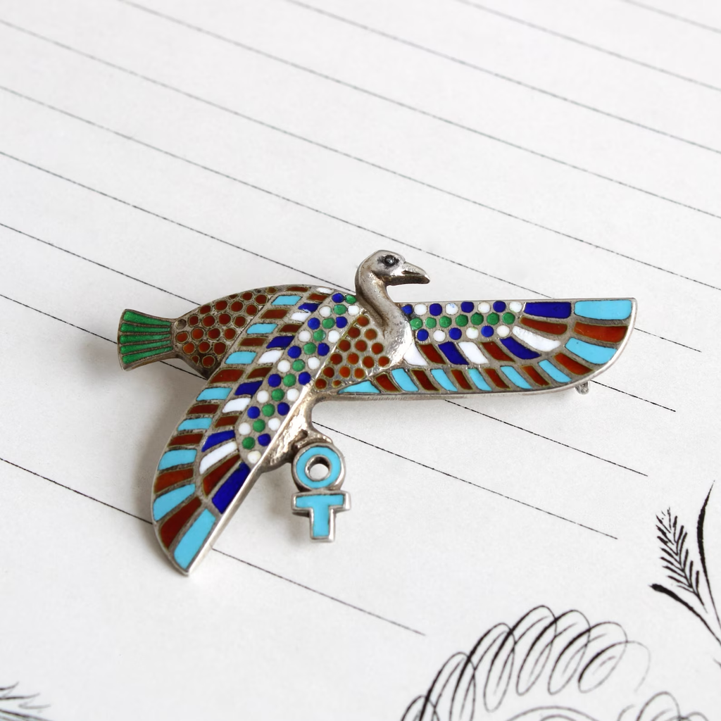 Antique silver winged Horus Egyptian revival pin with blue, green, white, and red enamel details.