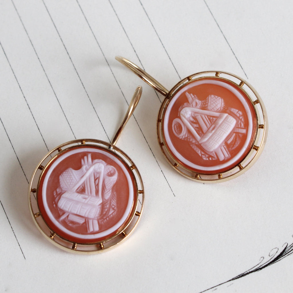 yellow gold drop earrings with round red agate cameos with fly fishing supplies carved into the faces