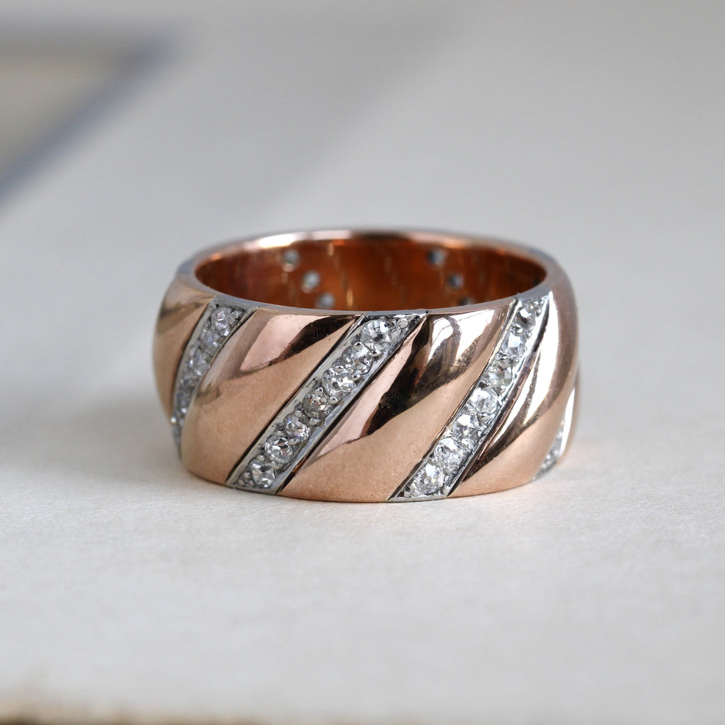 Vintage rose gold wide band ring with stripes of tiny diamonds.