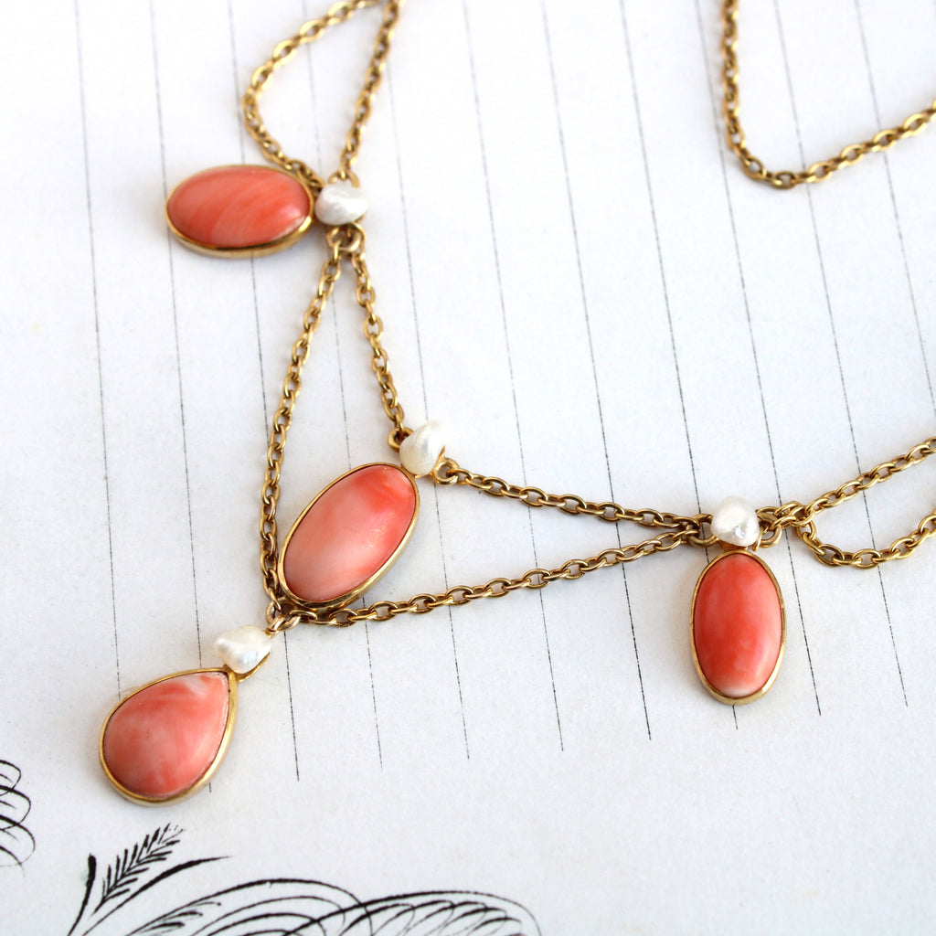 Antique yellow gold festoon necklace with oval cabochons and pearls dangling off the chain.