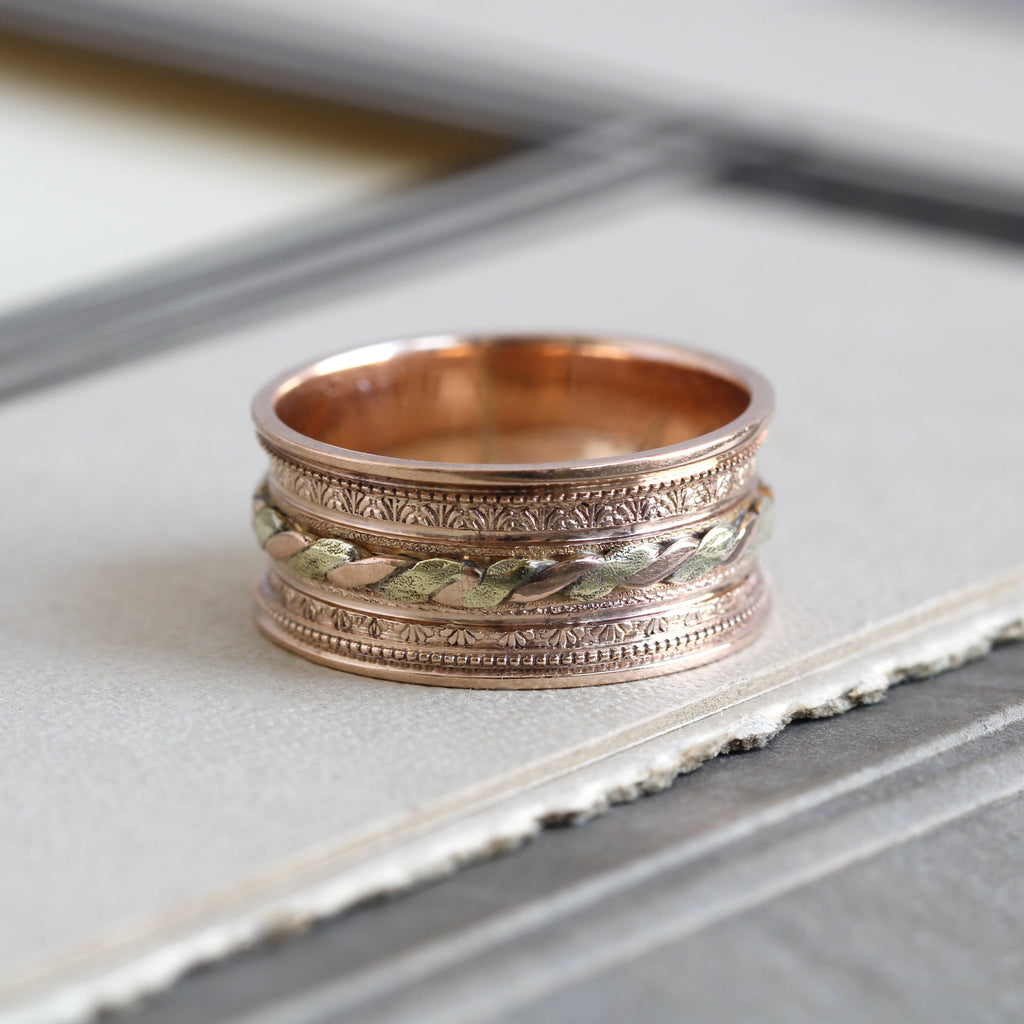 Antique two tone wide band with a twisted yellow gold and rose gold rope in the center.