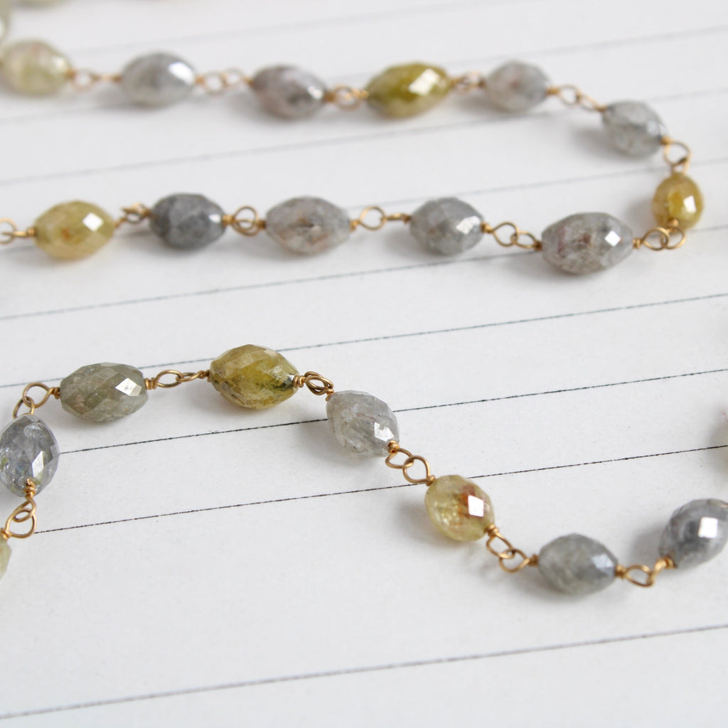 Yellow gold and multi color faceted oval diamond bead wire wrapped strand necklace.
