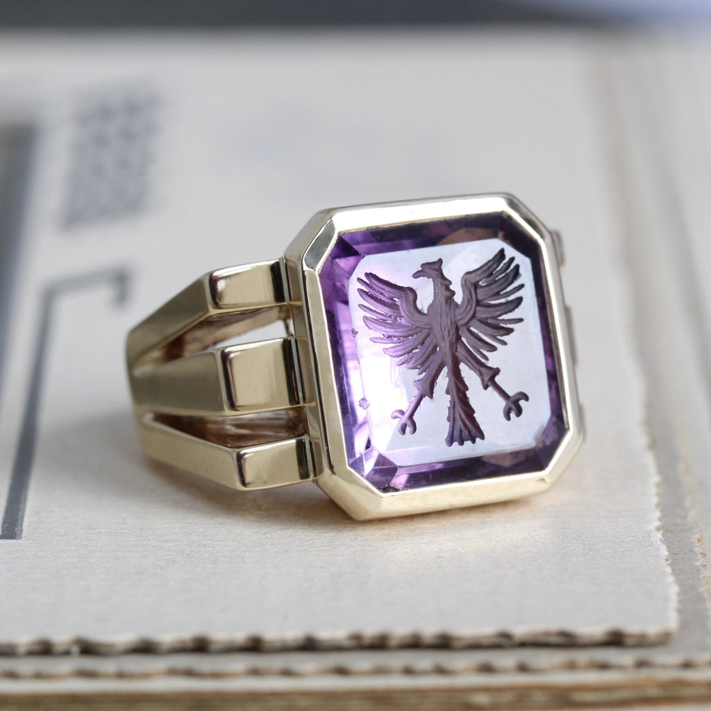 Antique yellow gold signet ring with a square amethyst intaglio carved with an eagle.
