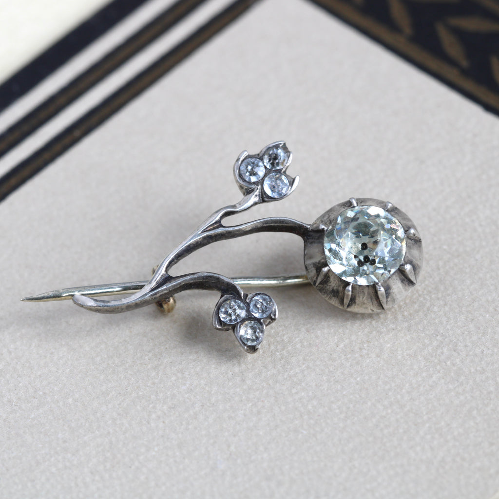 Antique sterling silver flower brooch pin with diamond paste stone detailing.